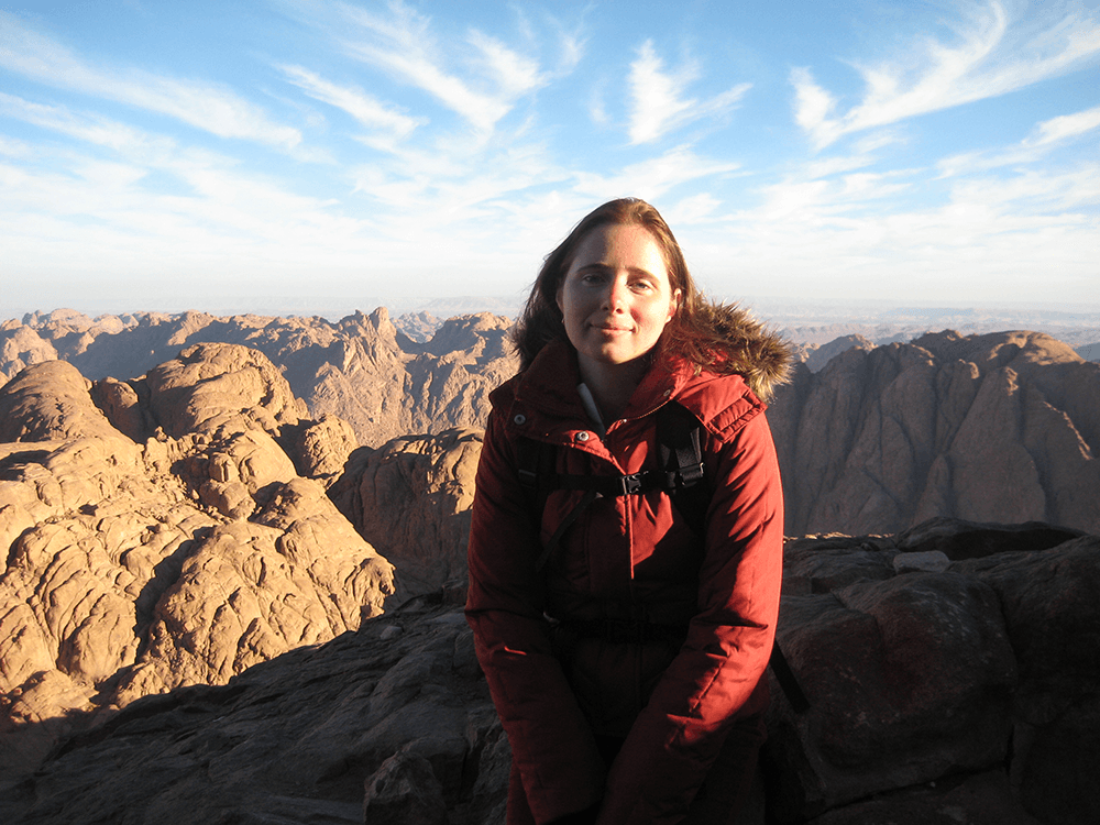 Elena sitting on a rock on a mountain top in Egypt